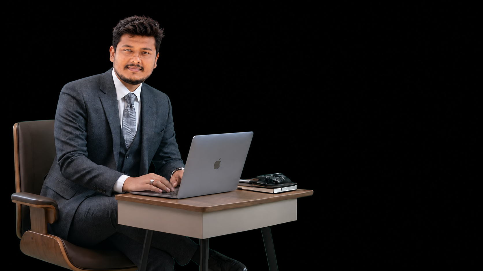 Sarim Noor seated at a desk with a laptop