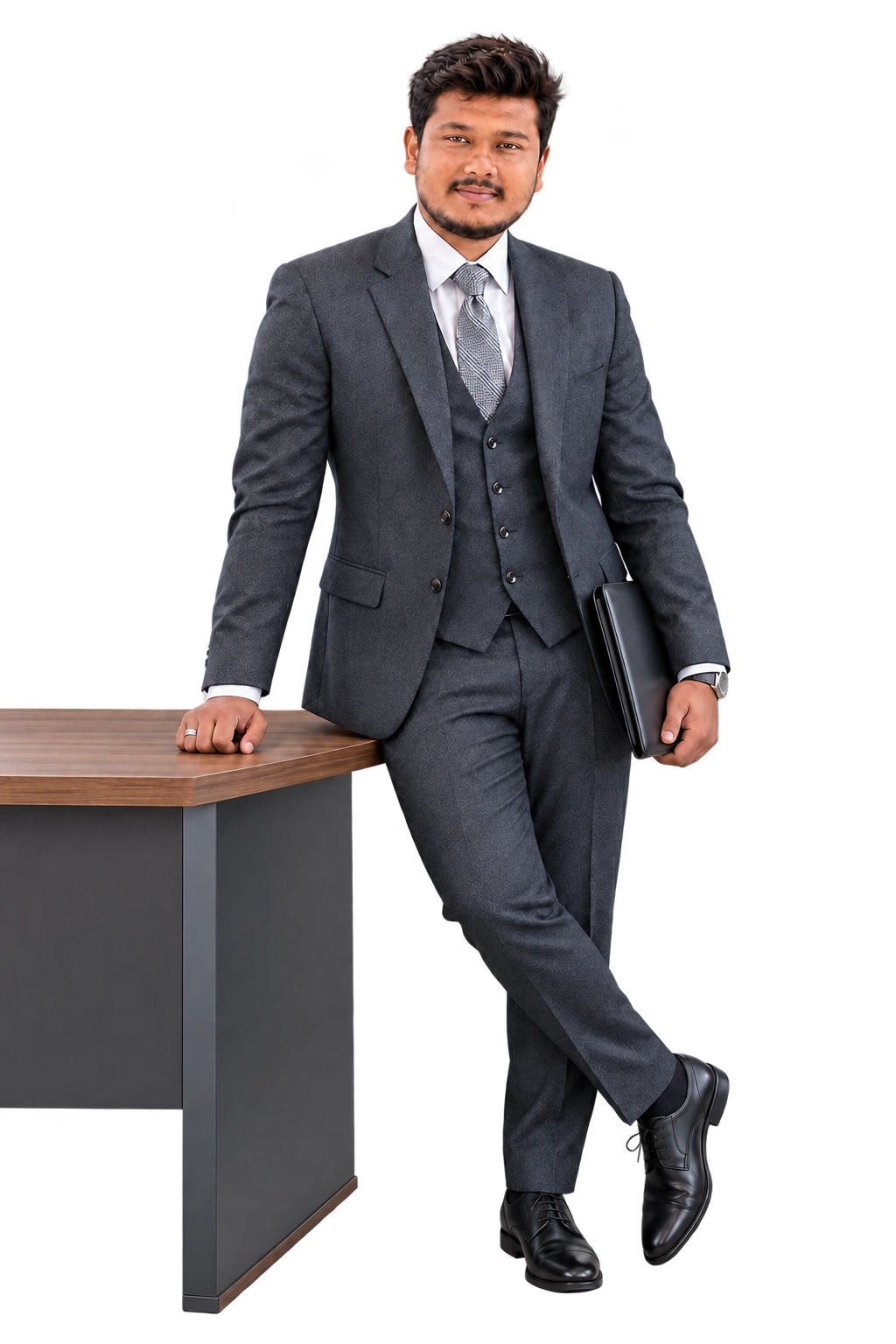 Sarim Noor standing beside a table in a formal business suit